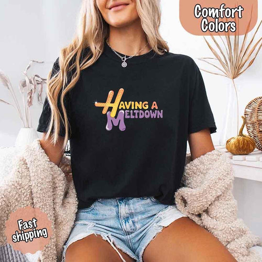 May include a woman wearing a black Comfort Colors T-shirt with the phrase “having a meltdown” in bold black text, styled for a humorous and relatable casual look.