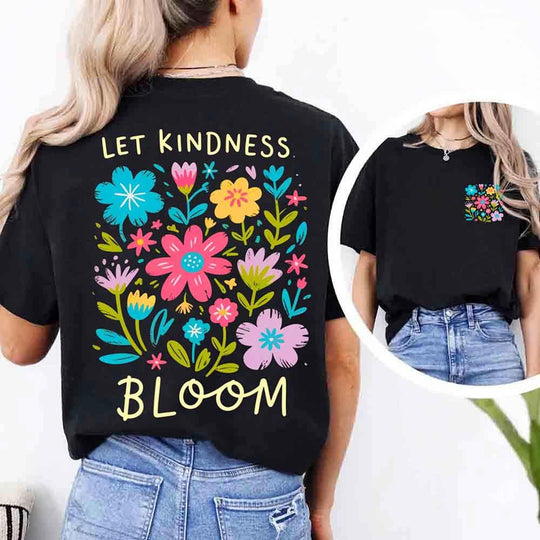May include a woman wearing a Black Comfort Colors T-shirt with colorful floral graphics and the phrase “Let Kindness Bloom” printed on the back, styled with light denim for a cheerful and uplifting look.