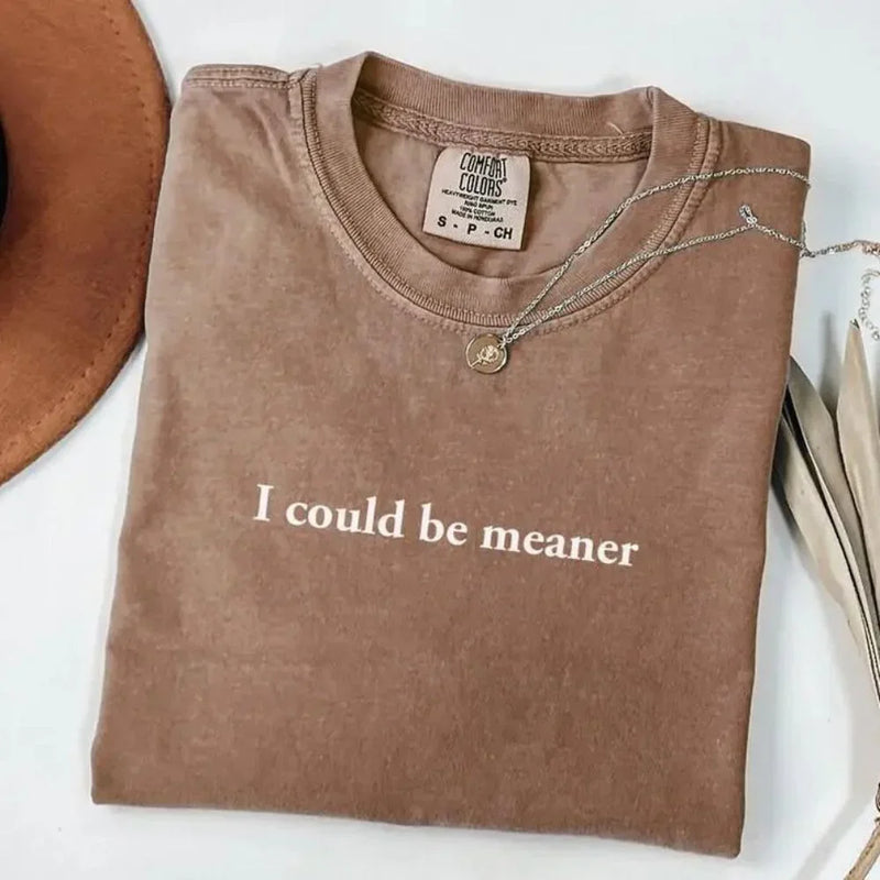 May include a unisex Comfort Colors T-shirt in a relaxed fit with short sleeves and crew neckline, featuring the phrase โI Could Be Meanerโ printed across the chest in bold, simple lettering.