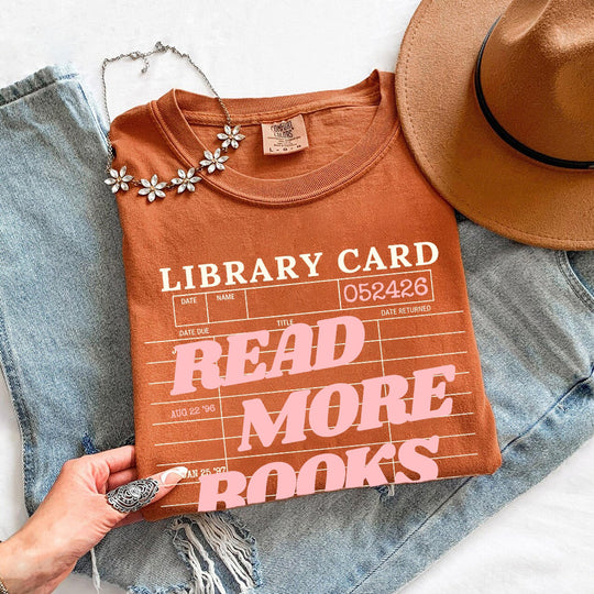 May include Library Card Comfort Colors unisex t-shirt with bookish graphic, relaxed fit, and soft garment-dyed cotton