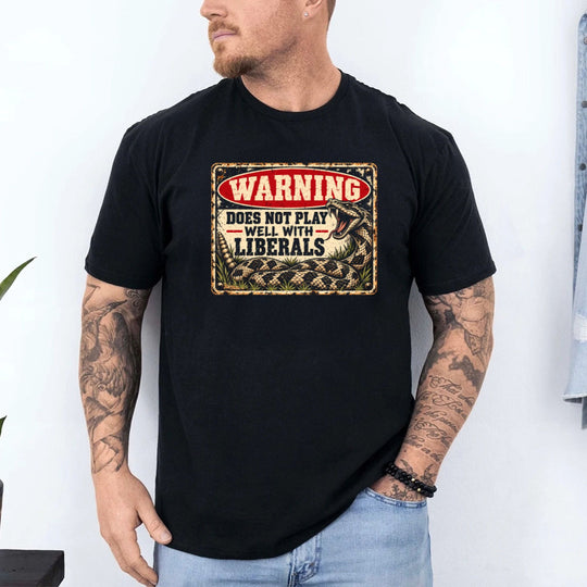 May include a Warning Does Not Play Well with Liberals Statement T-Shirt featuring a bold political phrase, designed for fans of political commentary, outspoken humor, and statement graphic apparel.