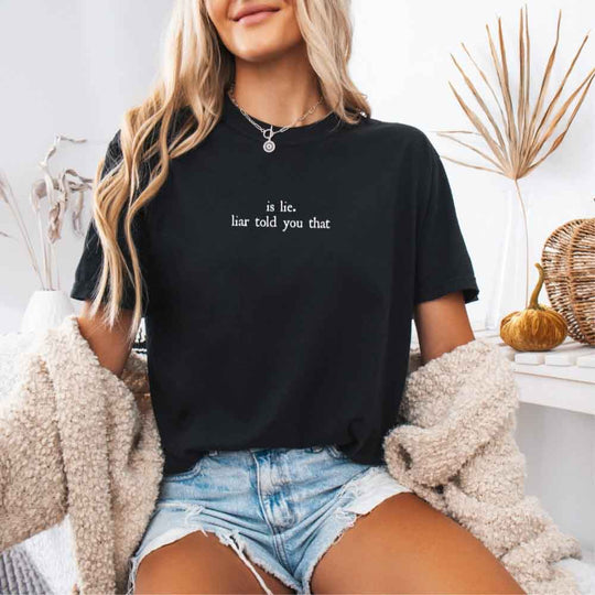 May include a person wearing a Black Is Lie Liar Told You That Comfort Colors T-Shirt featuring rivalry inspired graphic and relaxed fit.
