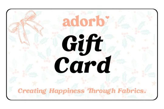 Gift card with holiday holly background, bow illustration, and text 'Creating Happiness Through Fabrics.'