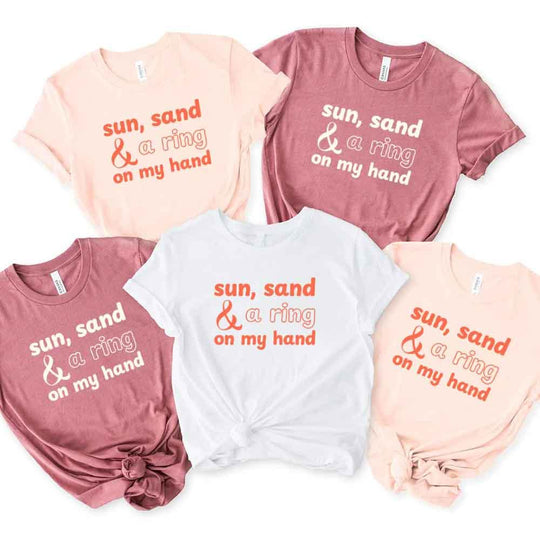 May include beach themed wedding party t-shirts with Sun Sand and A Ring On My Hand slogan, tropical colors, bridal group apparel for summer celebrations!