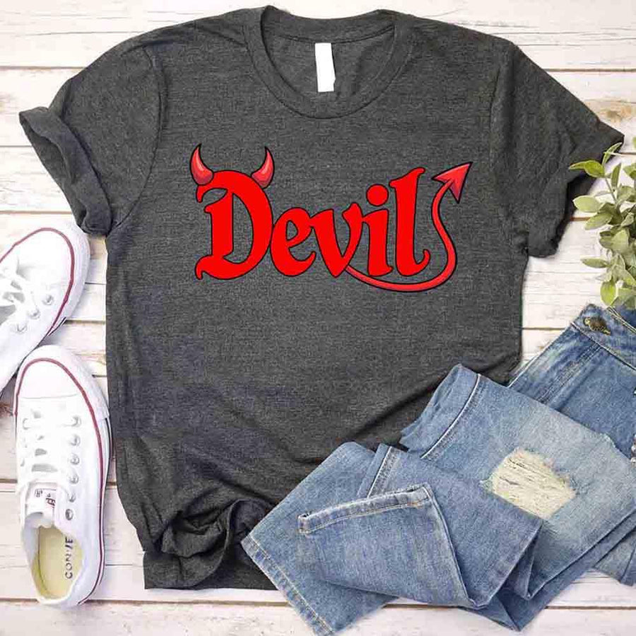Gray t-shirt with 'Devil' in red on a wooden surface with jeans and shoes.