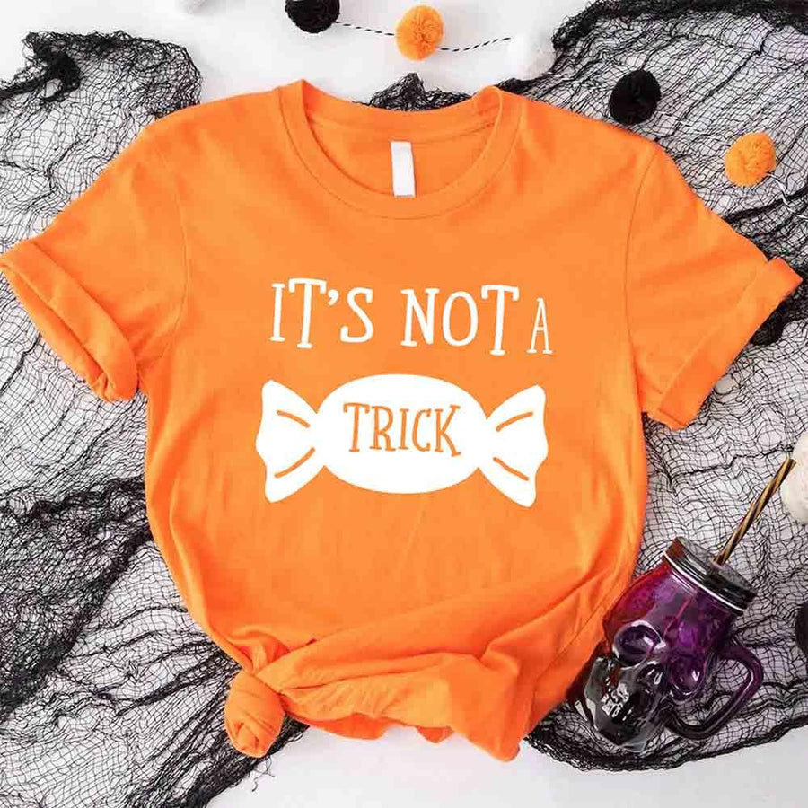 May include matching couple Halloween pregnancy announcement shirts, one reading ‘We’re Expecting a Little Treat’ with candy and baby footprints, and the other reading ‘It’s Not Trick’ with candy graphic – fun maternity reveal apparel.