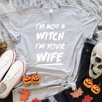 May include matching couple Halloween shirts with bold text, one reading ‘Get Back Witch’ and the other ‘I’m Not a Witch, I’m Your Wife’ – funny spooky graphic tees for couples.