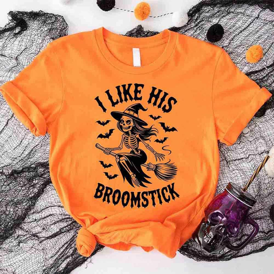Orange t-shirt with skeleton design and text on a Halloween-themed background