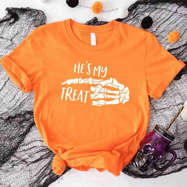 May include matching couple Halloween shirts with skeleton hand graphics, one reading ‘She’s My Trick’ on orange tee and the other reading ‘He’s My Treat’ on black tee – funny spooky couple apparel.