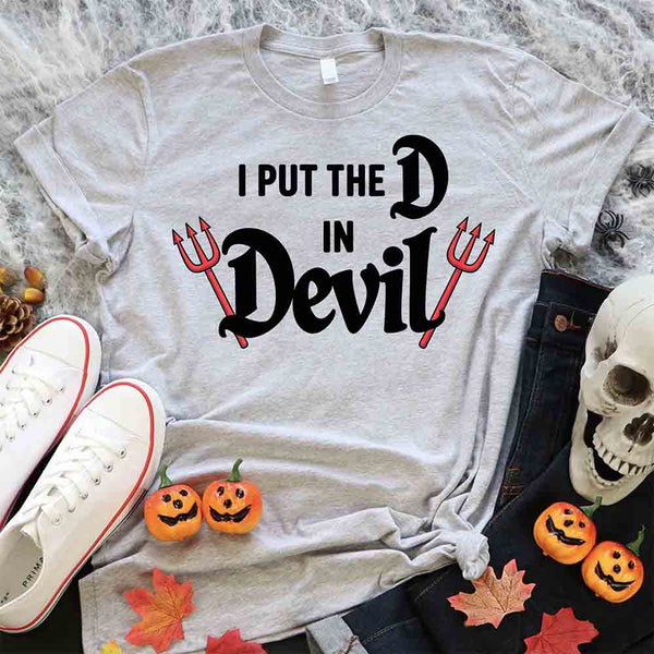 May include matching couple Halloween shirts, one with text ‘I Put the D in Devil’ in white with pitchfork graphic, and the other with bold red ‘Devil’ text featuring horns and tail – funny spooky couple tees.