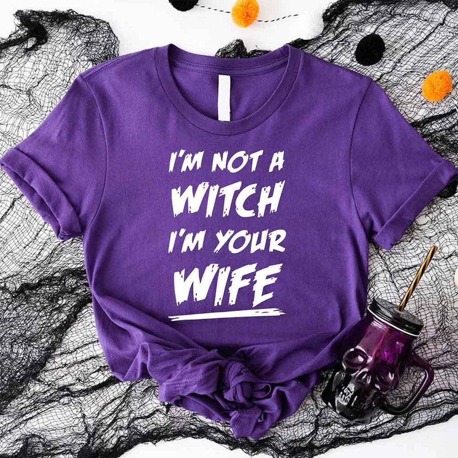 May include matching couple Halloween shirts with bold text, one reading ‘Get Back Witch’ and the other ‘I’m Not a Witch, I’m Your Wife’ – funny spooky graphic tees for couples.