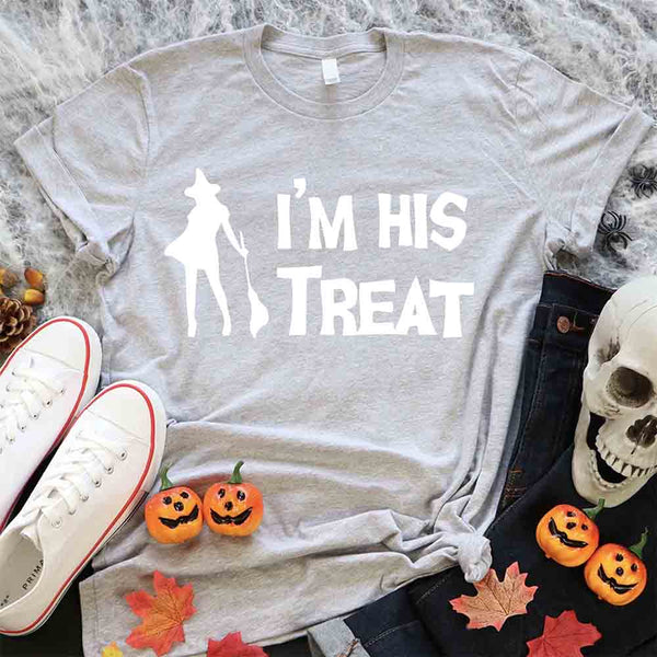 May include matching couple Halloween shirts with bold white text, one reading ‘I’m Her Trick’ with ghost graphic on orange tee, and the other reading ‘I’m His Treat’ with witch silhouette on black tee – funny spooky couple apparel.