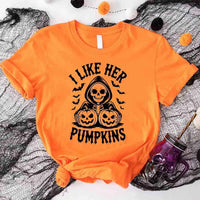 Orange t-shirt with Halloween design featuring a skeleton and pumpkins on a spider web background.