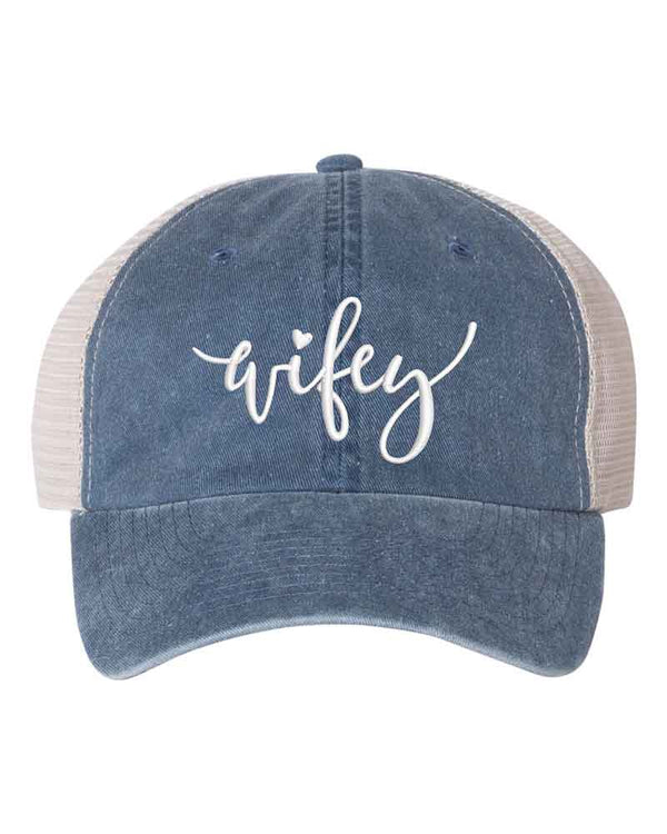 May include an embroidered pigment-dyed trucker hat with mesh back, featuring “Wifey” or “Hubby” text, designed as a casual and stylish gift for spouses or anniversaries.