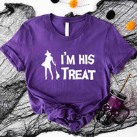 May include matching couple Halloween shirts with bold white text, one reading ‘I’m Her Trick’ with ghost graphic on orange tee, and the other reading ‘I’m His Treat’ with witch silhouette on black tee – funny spooky couple apparel.
