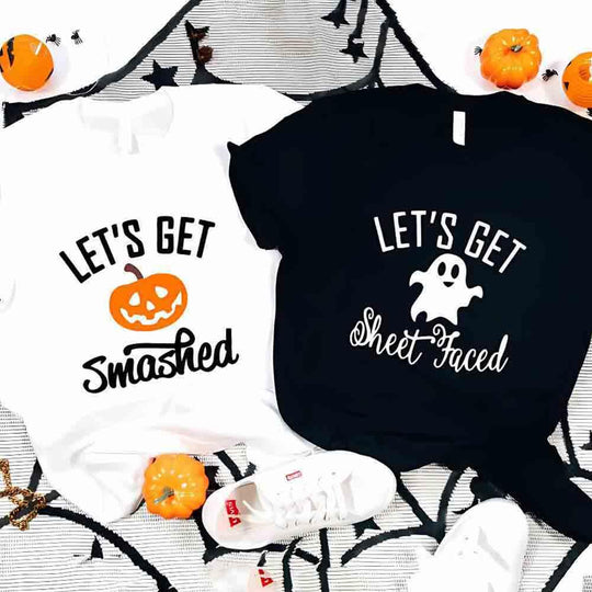 May include matching couple Halloween shirts with bold text, one reading ‘Let’s Get Smashed’ with jack-o’-lantern graphic on white tee, and the other reading ‘Let’s Get Sheet Faced’ with ghost graphic on black tee – funny spooky couple apparel.
