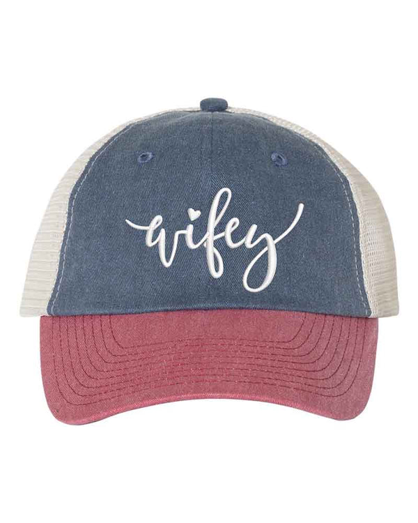 May include an embroidered pigment-dyed trucker hat with mesh back, featuring “Wifey” or “Hubby” text, designed as a casual and stylish gift for spouses or anniversaries.