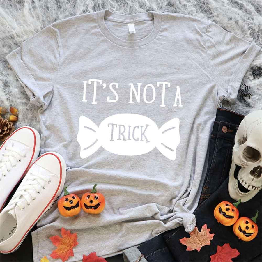 May include matching couple Halloween pregnancy announcement shirts, one reading ‘We’re Expecting a Little Treat’ with candy and baby footprints, and the other reading ‘It’s Not Trick’ with candy graphic – fun maternity reveal apparel.