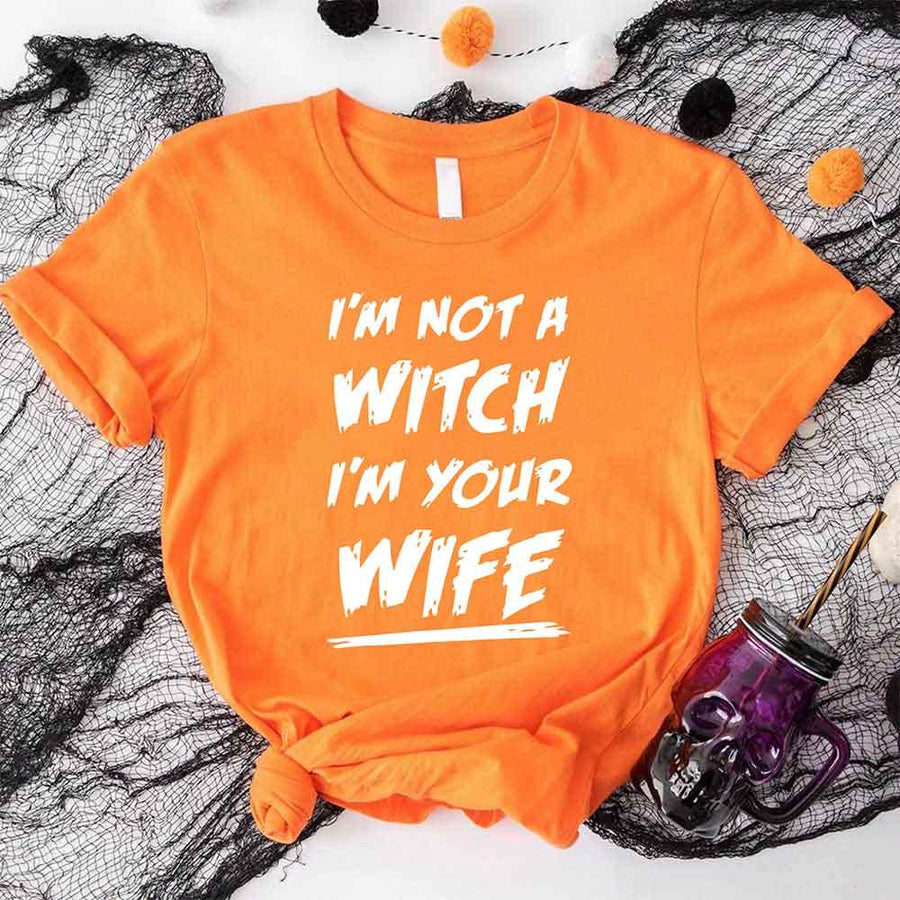 May include matching couple Halloween shirts with bold text, one reading ‘Get Back Witch’ and the other ‘I’m Not a Witch, I’m Your Wife’ – funny spooky graphic tees for couples.