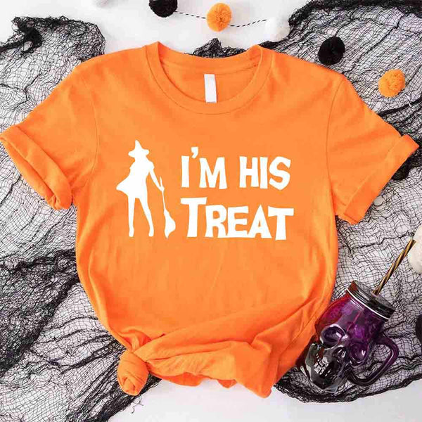 May include matching couple Halloween shirts with bold white text, one reading ‘I’m Her Trick’ with ghost graphic on orange tee, and the other reading ‘I’m His Treat’ with witch silhouette on black tee – funny spooky couple apparel.