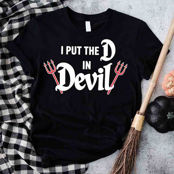 May include matching couple Halloween shirts, one with text ‘I Put the D in Devil’ in white with pitchfork graphic, and the other with bold red ‘Devil’ text featuring horns and tail – funny spooky couple tees.