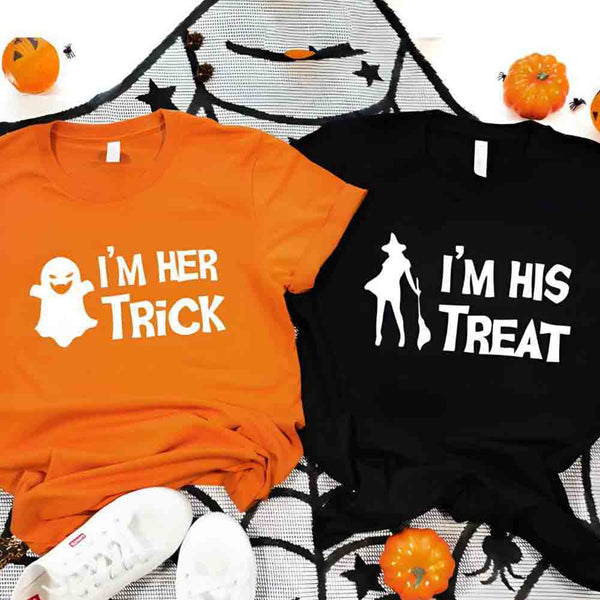 Two Halloween-themed t-shirts, one orange and one black, with ghost and ghostbusters graphics on a spider web background.