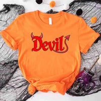 Orange t-shirt with 'Devil' print on a Halloween-themed background