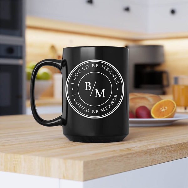 Black mug with 'B/M' logo on a kitchen counter