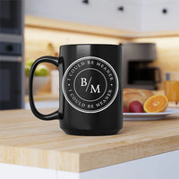 Black mug with 'B/M' logo on a kitchen counter