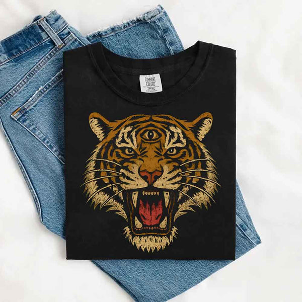 May include a folded Comfort Colors Black T-shirt with a detailed tiger graphic inspired by 90s jungle safari aesthetics, laid over denim jeans for a bold and nostalgic feel.