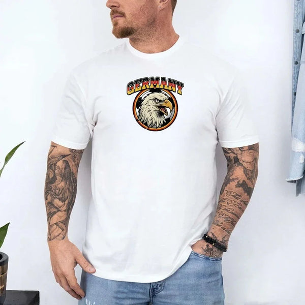 White Germany soccer fan t-shirt with eagle logo, worn by tattooed man.
