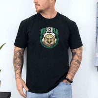 Man wearing black Nigeria soccer fan shirt with eagle graphic and bold green lettering.