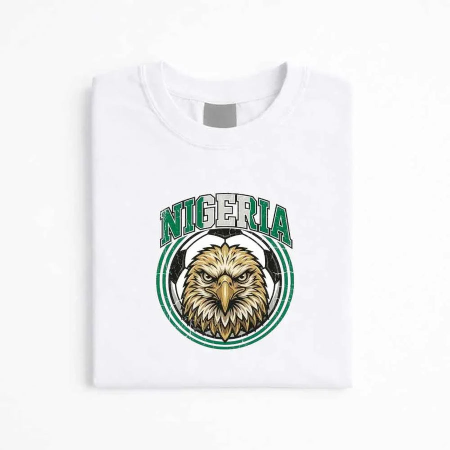 White Nigeria soccer fan T-shirt with eagle and soccer ball graphic emblem.