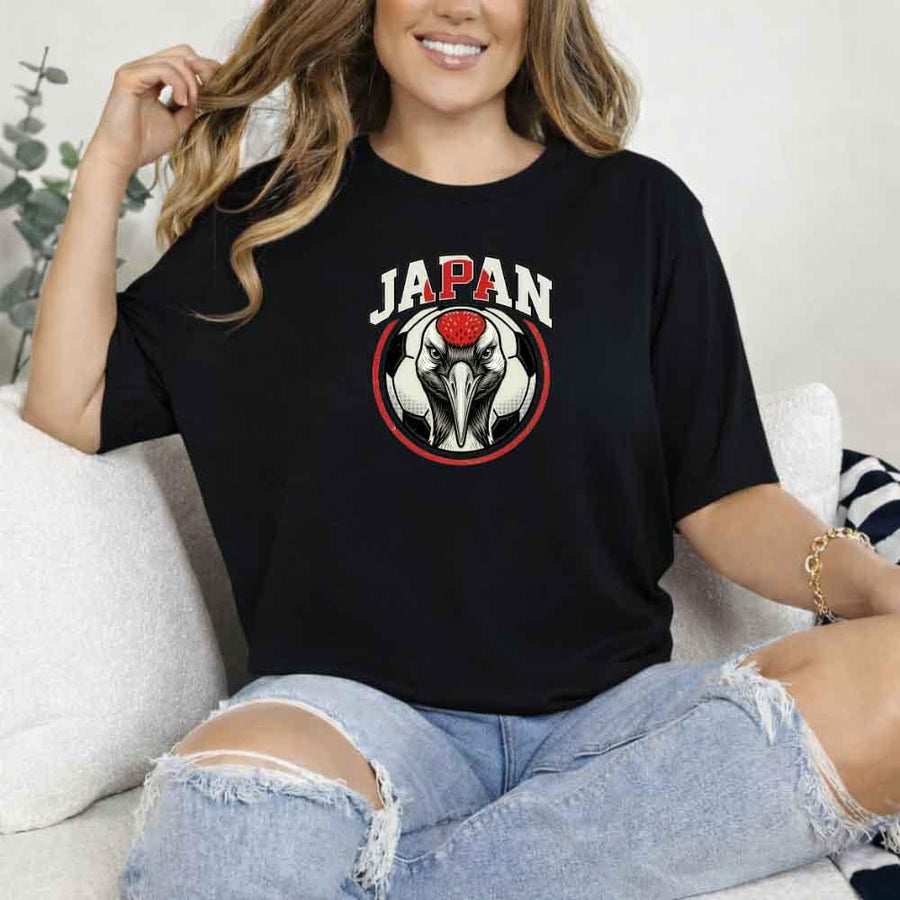 Woman wearing black Japan soccer t-shirt with red-crowned crane and ball graphic