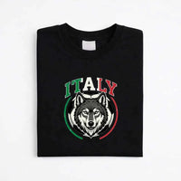 Black Italy soccer T-shirt with wolf graphic and tricolor design, folded on white background
