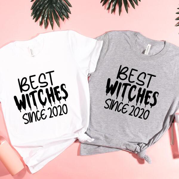 Two personalized T-shirts, one white and one gray, with the text 'BEST WITCHES SINCE 2021' printed on the front.