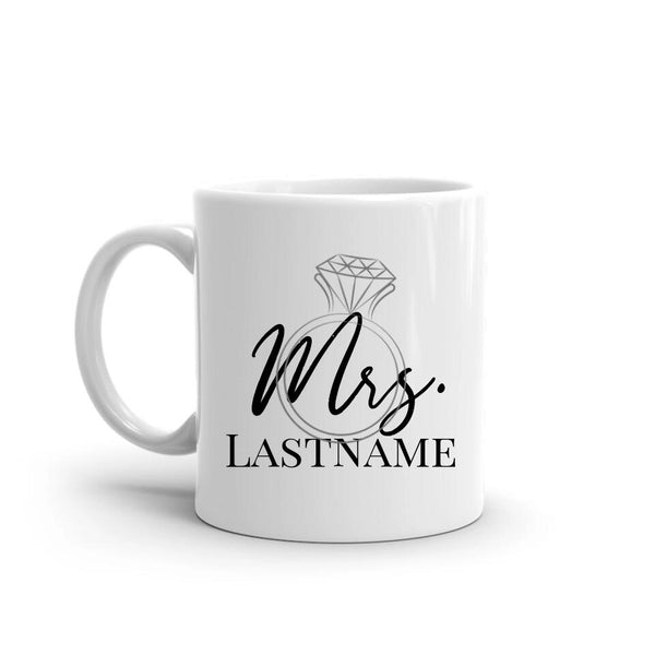 White mug with 'Mrs. Lastname' text and diamond ring design on a white background