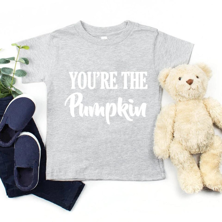 Gray t-shirt with 'YOU'RE THE Pumpkin' text, navy shorts, blue shoes, and a teddy bear on a white background