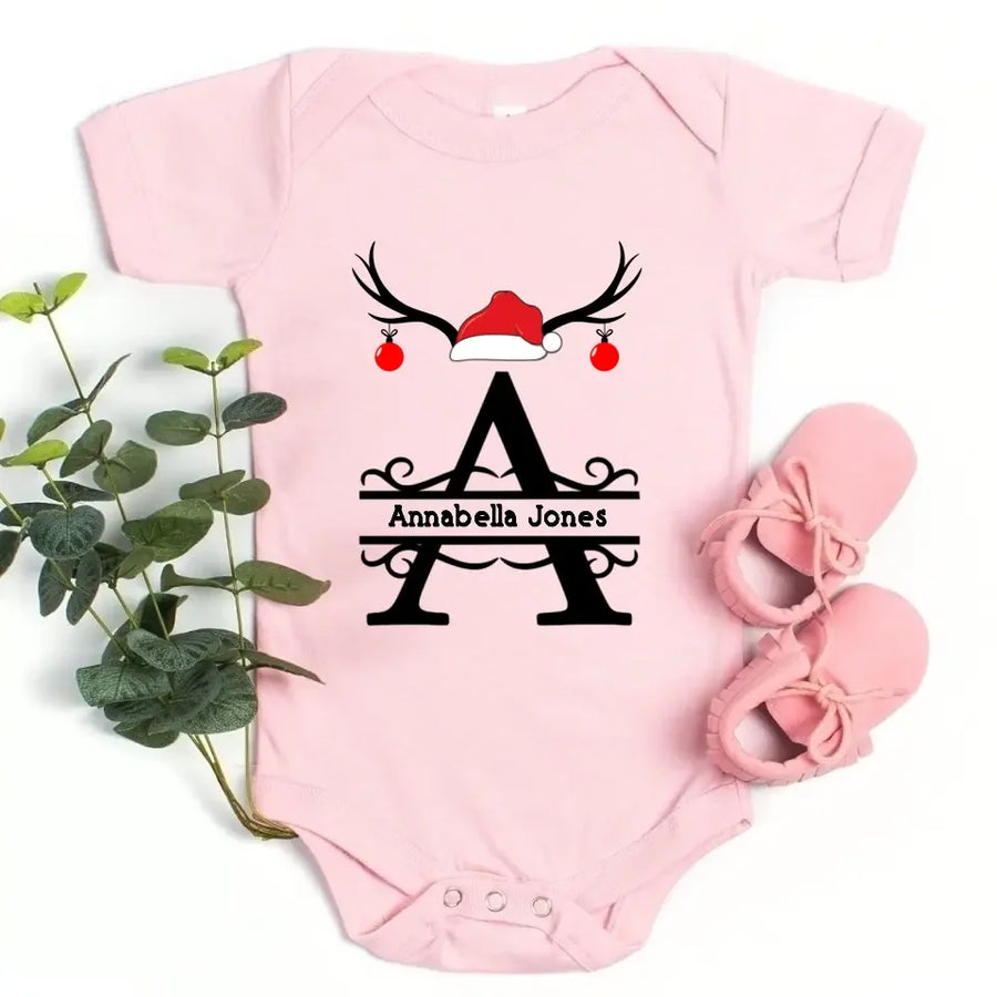 May include a personalized Christmas T-shirt with a single initial printed in a holiday-themed design on the front.
