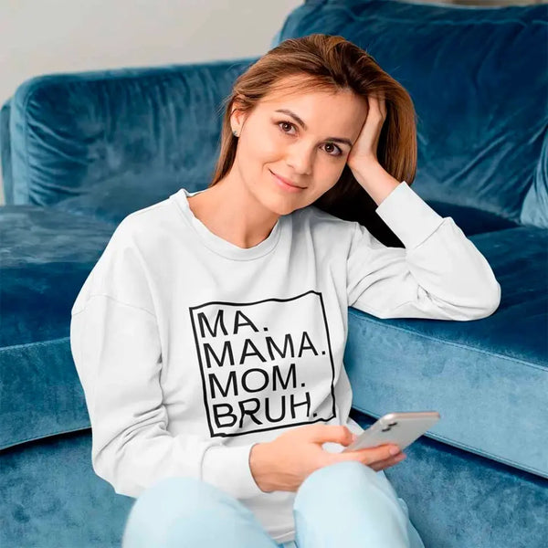 Woman wearing a sweatshirt with text sitting on a blue couch.
