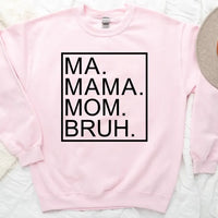 Pink sweatshirt with text 'MA. MAMA. MOM. BRUH.' on a light background