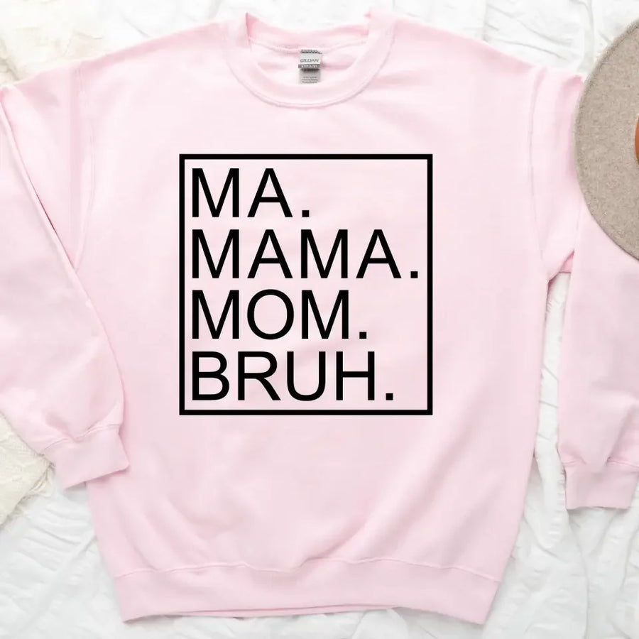 Pink sweatshirt with text 'MA. MAMA. MOM. BRUH.' on a light background