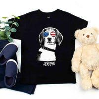 Black t-shirt with a dog graphic and 'Jericho' text, placed on a white surface with a teddy bear and shoes.
