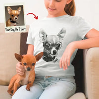 Person wearing a t-shirt with a dog's face printed on it, sitting on a couch with a small dog.