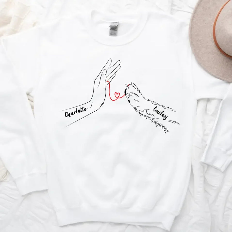 May include a personalized shirt with a dog paw and human hand joined by a red thread heart, with space for a custom pet name.
