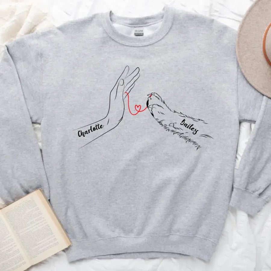 May include a personalized shirt with a dog paw and human hand joined by a red thread heart, with space for a custom pet name.