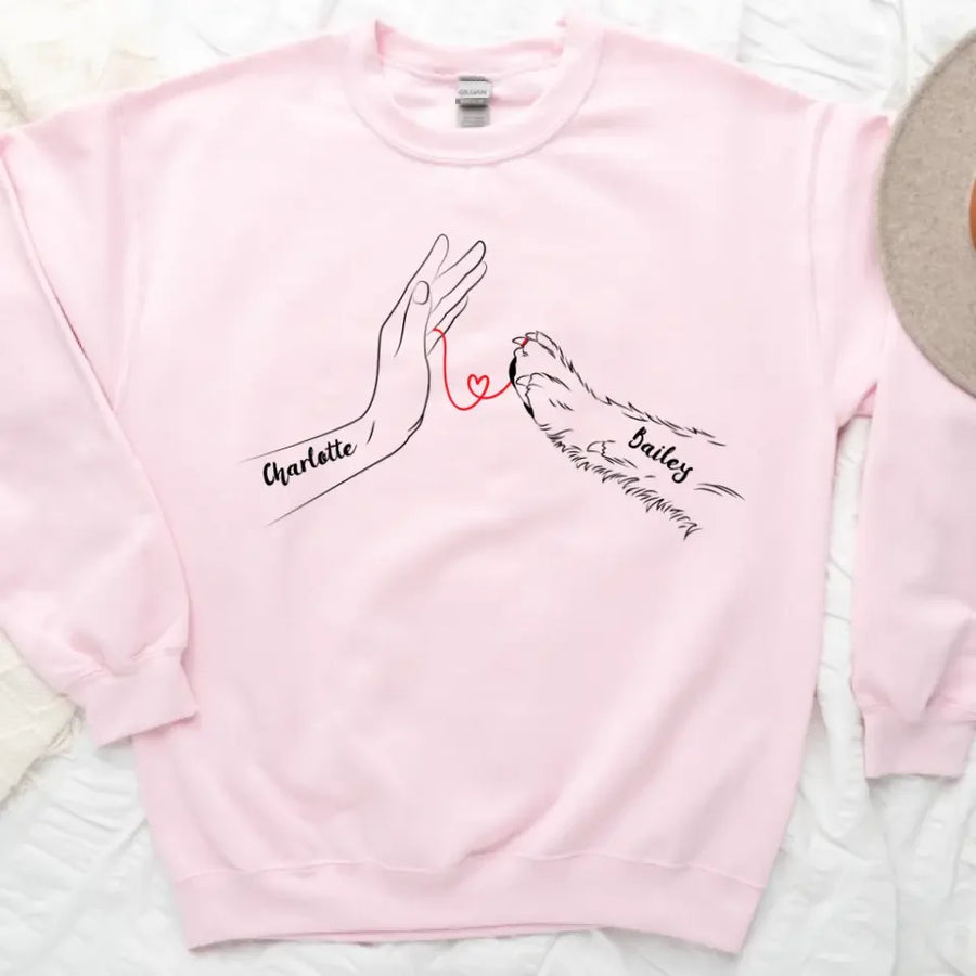 May include a personalized shirt with a dog paw and human hand joined by a red thread heart, with space for a custom pet name.
