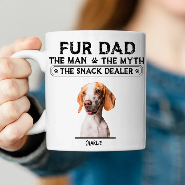 Person holding a mug with 'Fur Dad' text and dog illustration