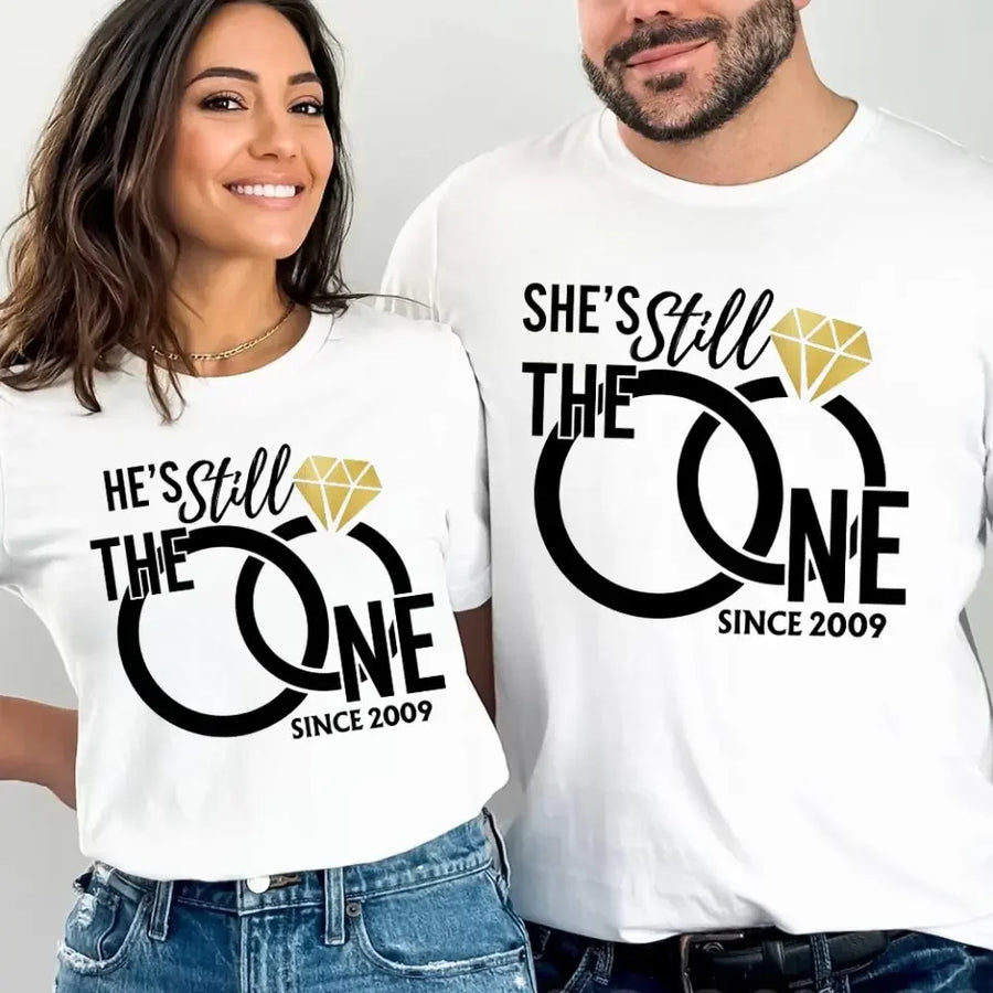 Two people wearing matching white t-shirts with humorous text and design.