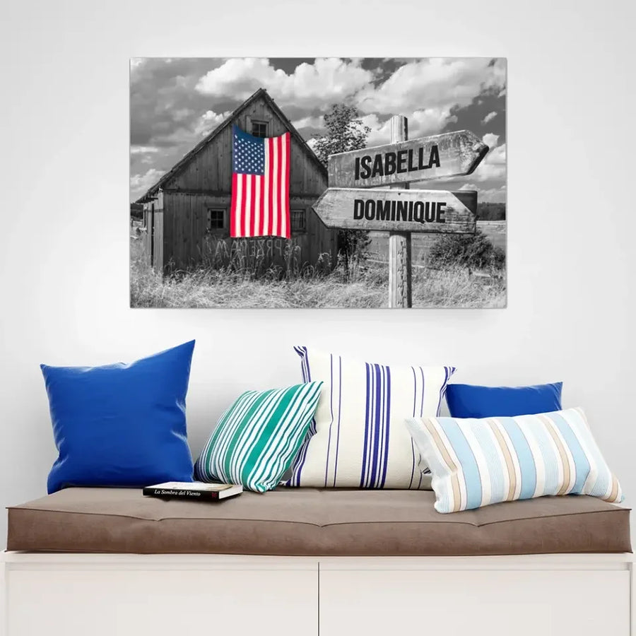 Wall art with rustic barn, American flag, and personalized Isabella and Dominique sign, above sofa.